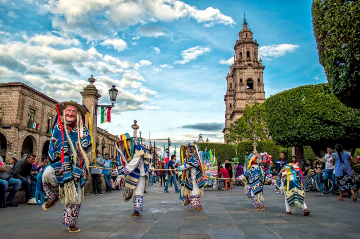 Colorful traditional dance performance at a Mexican festival in front of a historic church.